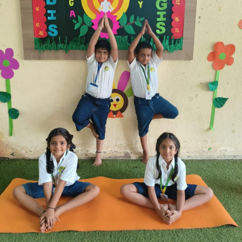 Children gather with enthusiasm, ready to celebrate Yoga Day at school.